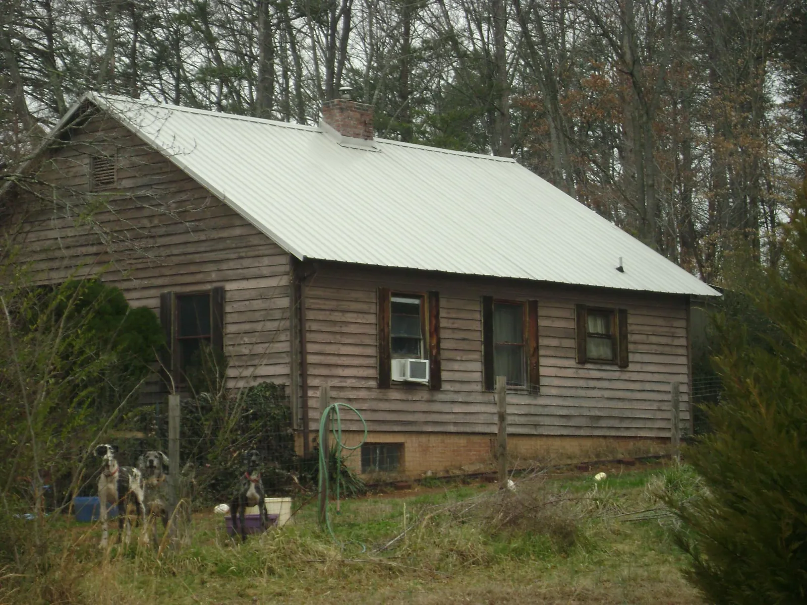 White metal roof on an old wood sided farmhouse, from a Metal Roof Installation job in Phoenix